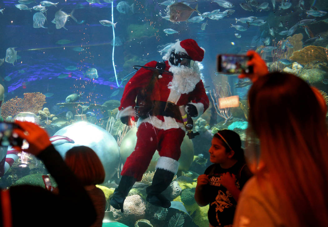 Underwater Santa saluda a la multitud en el hotel y casino Silverton en Las Vegas, el domingo 2 de diciembre de 2018. Él y la sirena navideña están en el acuario todos los sábados y domingos d ...