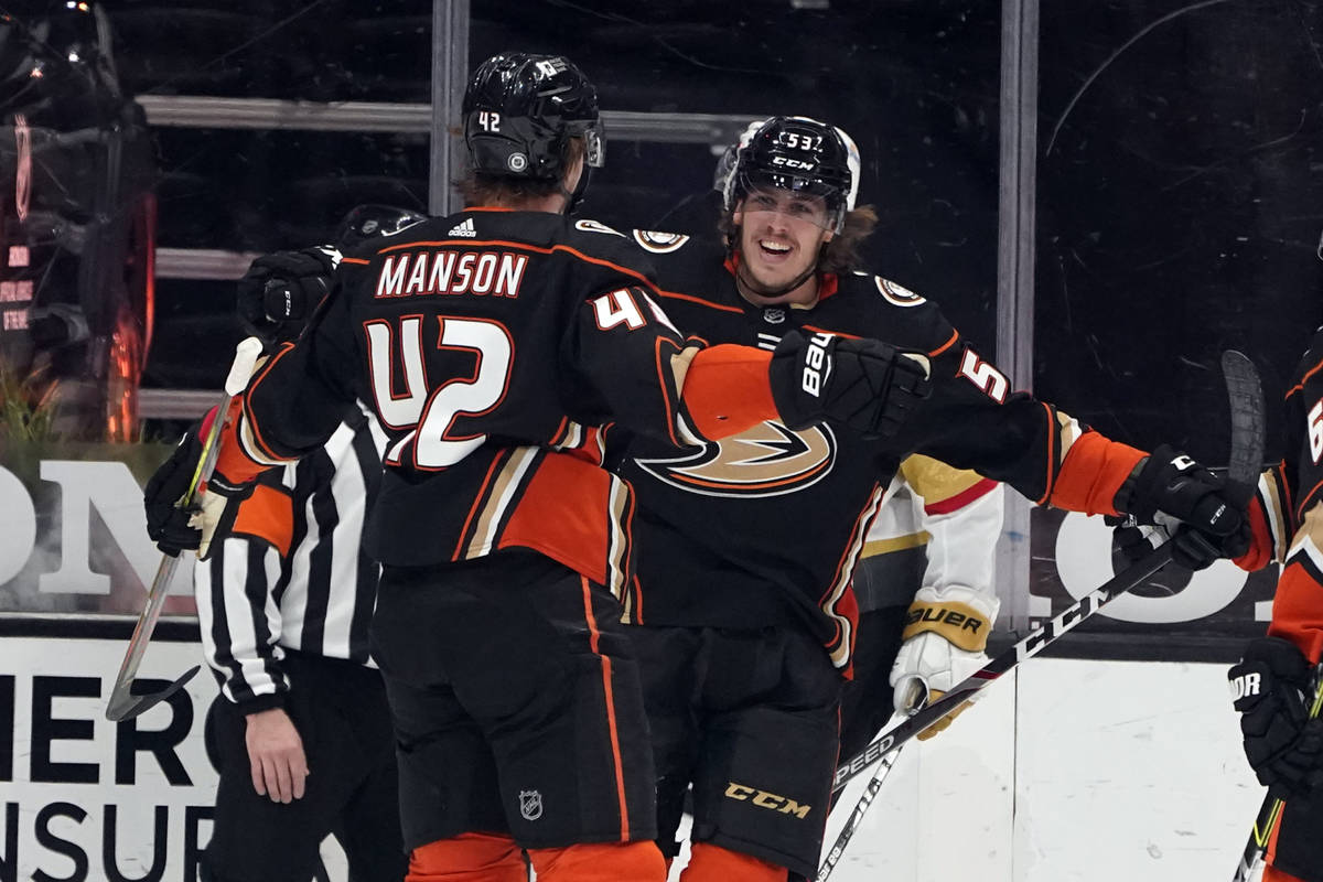 El ala izquierda de los Anaheim Ducks, Max Comtois, a la derecha, celebra con Josh Manson (42) ...