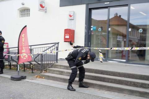 Police search for evidence outside the Coop store in after a man killed several people, in Kong ...